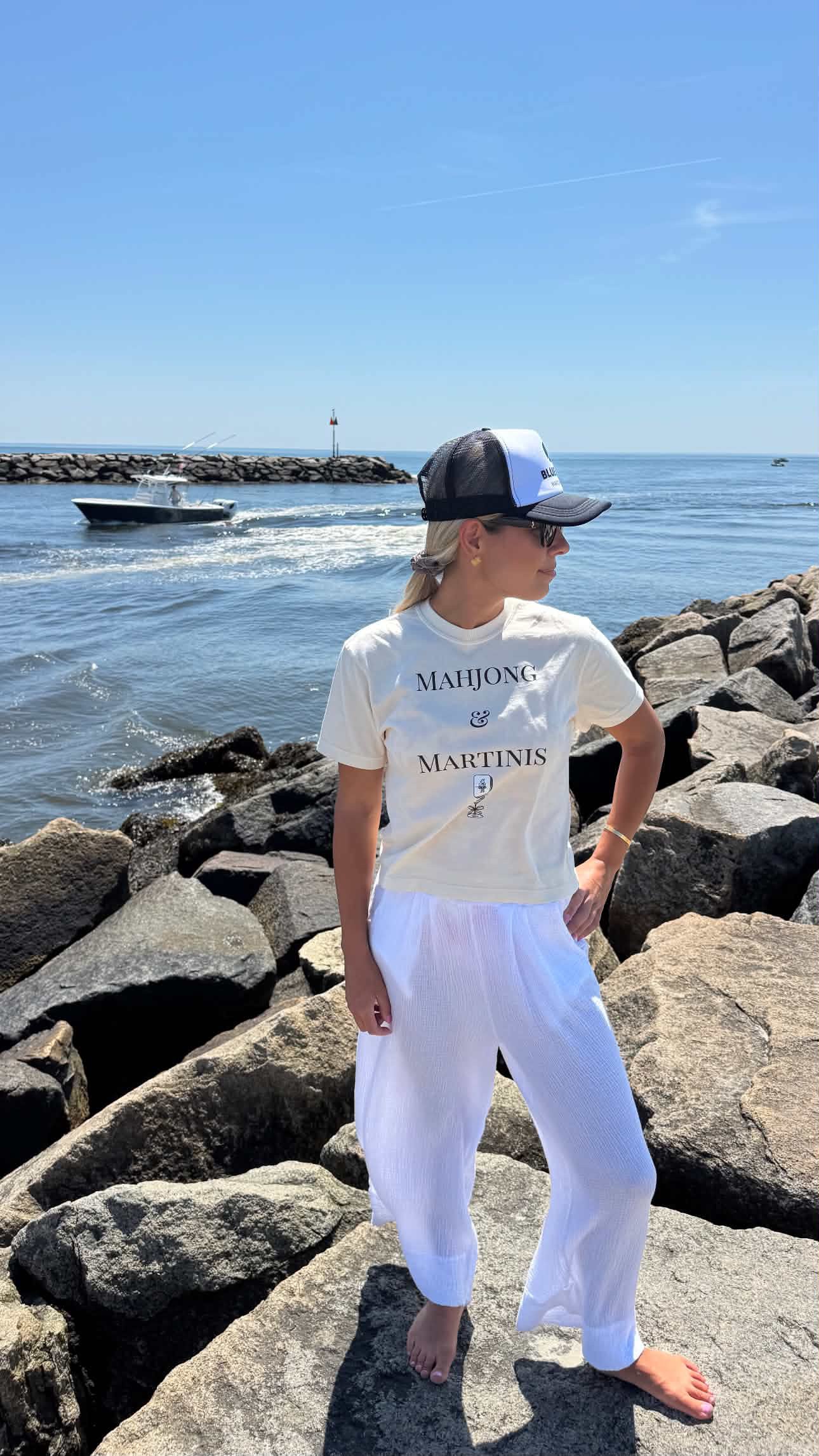 Woman wearing Mahjong & Martinis graphic t-shirt on beach